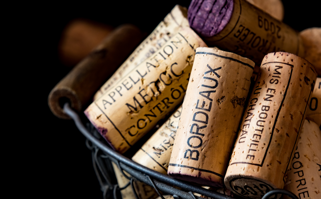 A basket full of wine corks, with the word Bordeaux printed on the corks